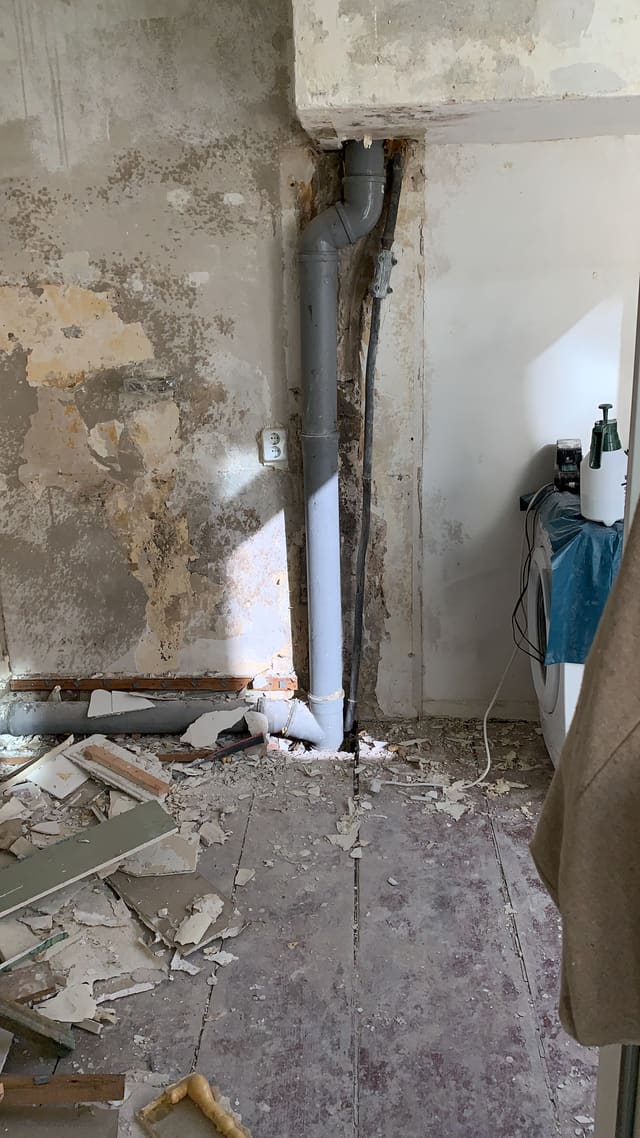 Floor opened up to expose old pipework during a strip-out