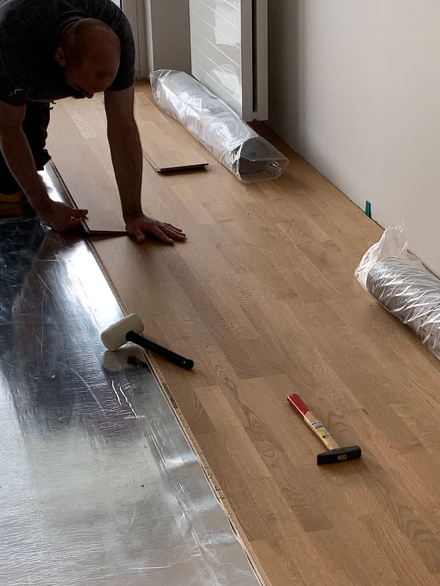 Fitting insulation and wood panelling to an attic ceiling