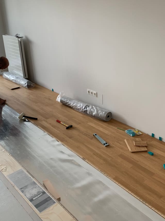 Installing panelling in an attic conversion, radiator visible