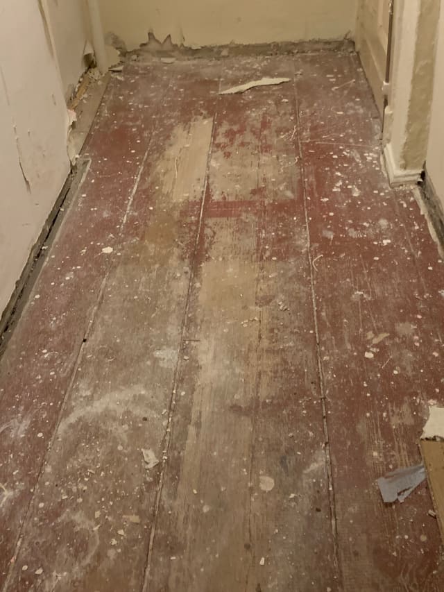 Old distressed wood and brick wall before renovation