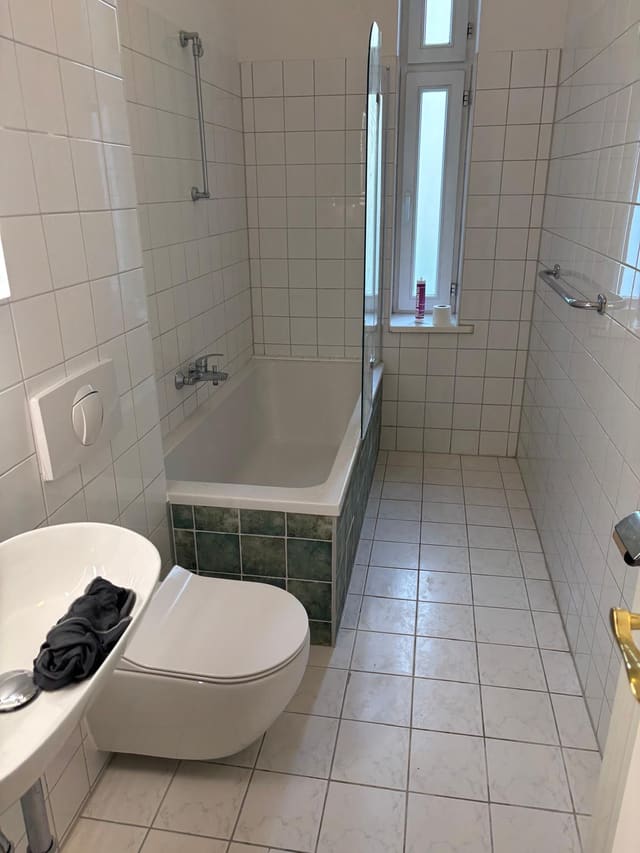 Finished bathroom with white metro tiles and bathtub