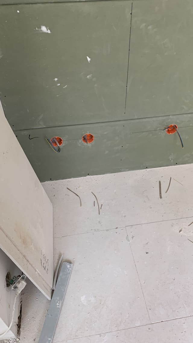 First-fix wiring with three back boxes set into drywall ahead of plastering