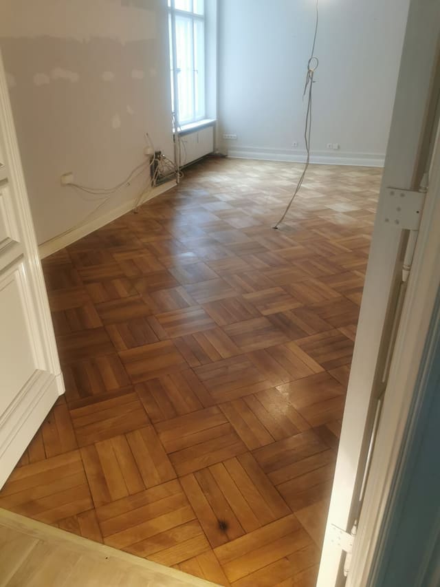 Restored herringbone parquet corridor in a Berlin Altbau flat