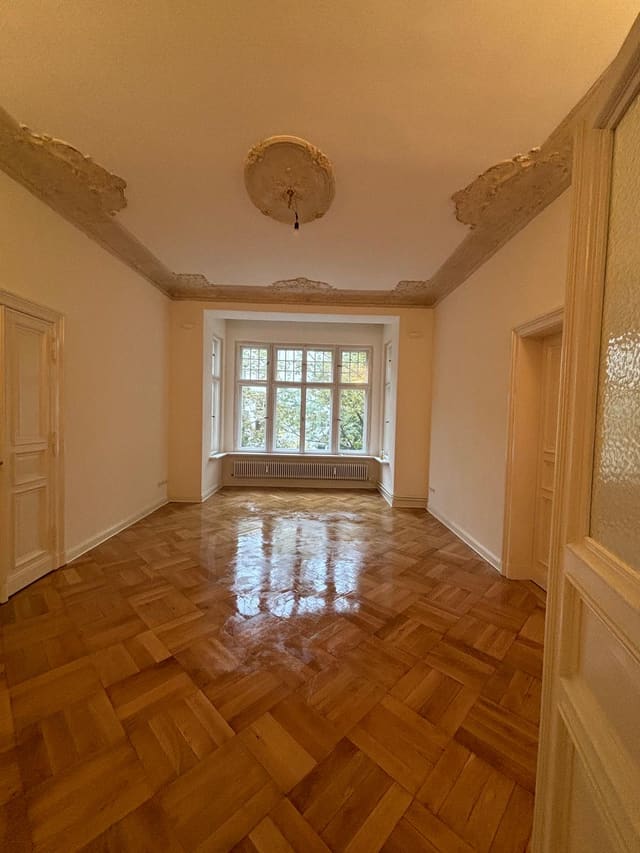 Empty room with sanded and refinished parquet flooring
