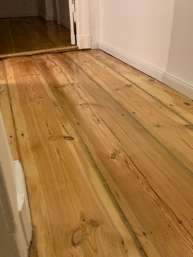Freshly sanded and refinished wood plank flooring